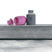 ck worldwide super cup sitting next to broken alumina cup