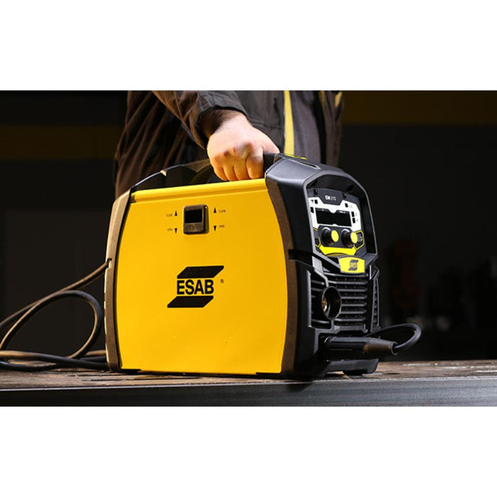 close up of man carrying esab em210 mig welder to show portability