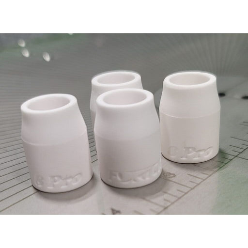 4 white ceramic tig cups placed on a measurement grid to show size