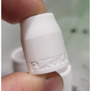 an individual white ceramic tig cup held inbetween someones fingers