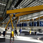 a series of column mounted welding booms in a factory