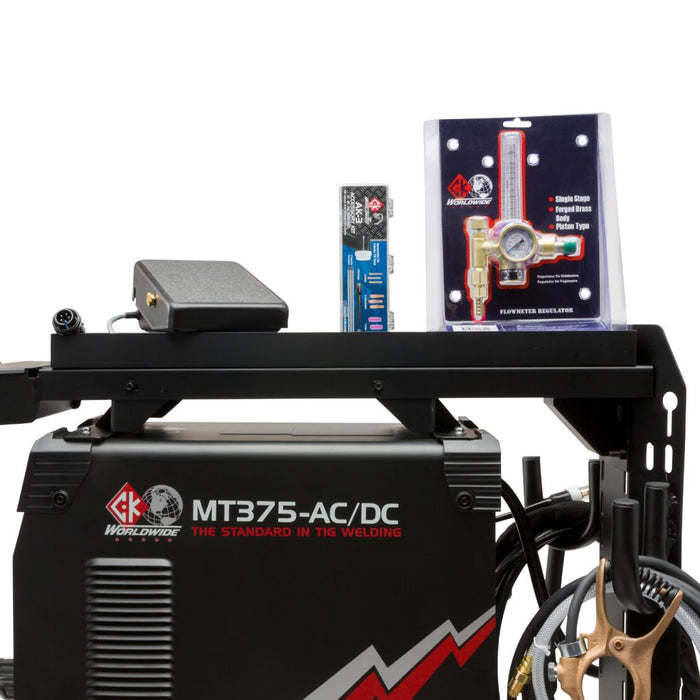 side angle of welder cart showing mt375 ac/dc logo with accessories and foot pedal on top of cart