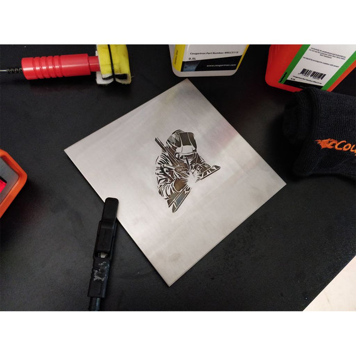 sheet of stainless steel with artwork of tig welder etched in to it
