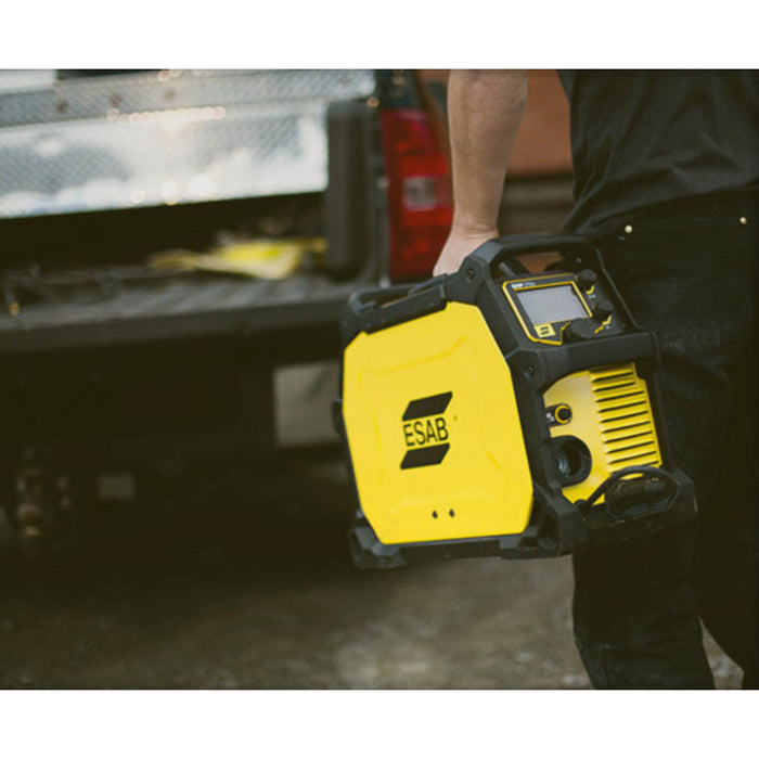 close up of someone easily carrying the portable esab rebel EMP 215ic welder