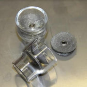 two furick glass cups on a table with a spare diffuser screen next to them