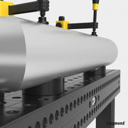 close up of steel pipe being supported by two 80mm prisms on siegmund system 16 welding table