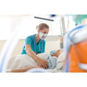 elderly patient recieving care from a healthcare worker wearing a clear n95 mask smiling